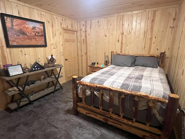 bedroom with wood ceiling and wooden walls