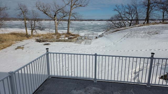 view of snow covered back of property