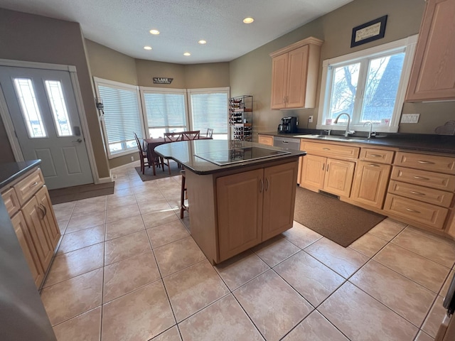 kitchen with dark countertops, light tile patterned floors, and a sink