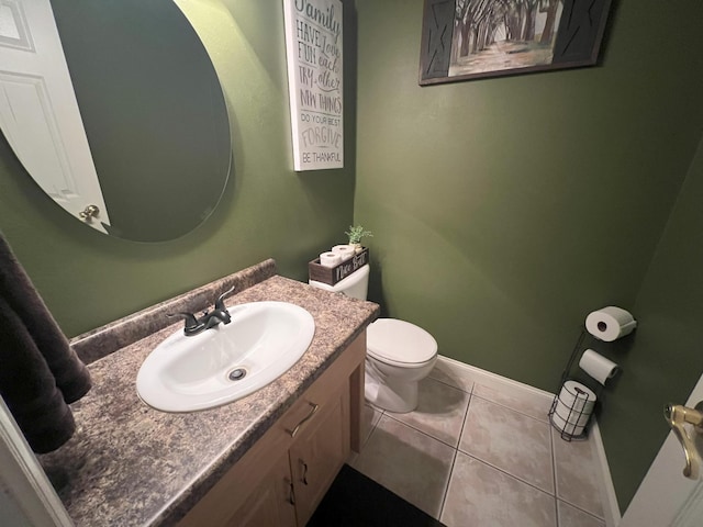 bathroom with tile patterned flooring, vanity, toilet, and baseboards