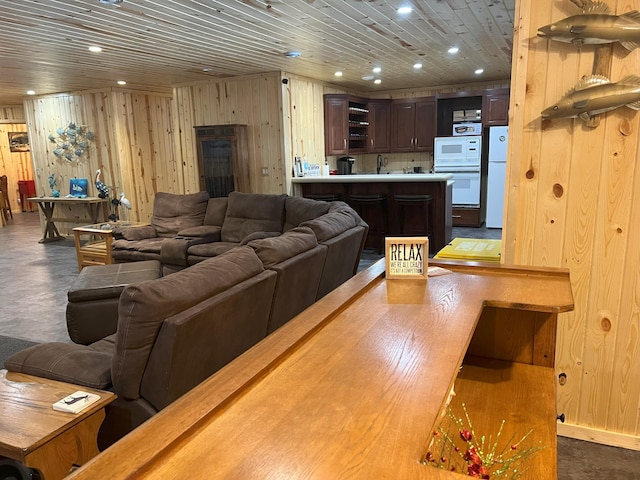 living area with recessed lighting, wood ceiling, and wooden walls