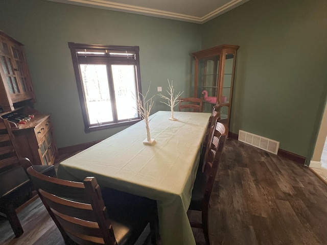 11999 Lake Maud Trl, Lake Eunice Twp, MN 56511 - dining room with baseboards, ornamental molding, dark wood finished floors, and visible vents