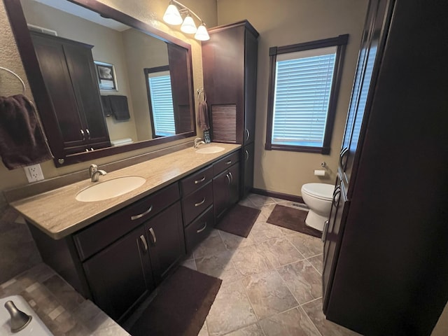 11999 Lake Maud Trl, Lake Eunice Twp, MN 56511 - full bath featuring double vanity, toilet, baseboards, and a sink