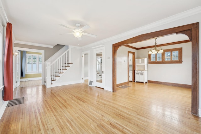 unfurnished room with light wood-style floors, visible vents, stairway, and baseboards