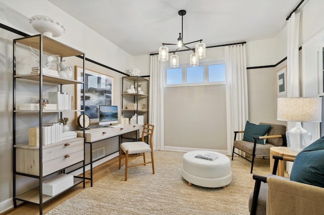 office with a notable chandelier, baseboards, and wood finished floors