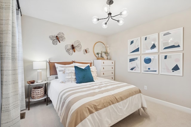 carpeted bedroom with a notable chandelier and baseboards