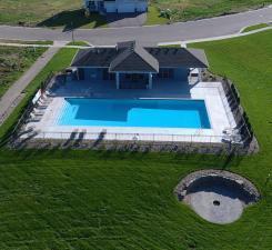 view of swimming pool featuring a lawn and a fenced in pool