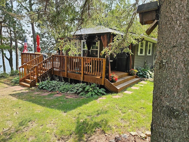 exterior space featuring a lawn and a water view