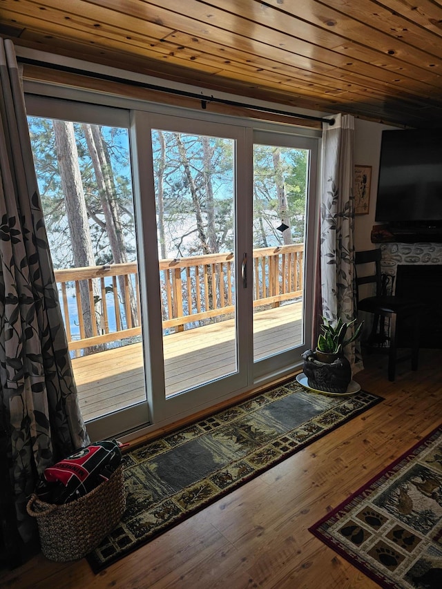 doorway with wood ceiling, a fireplace, and hardwood / wood-style flooring