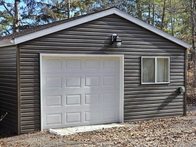 detached garage with dirt driveway