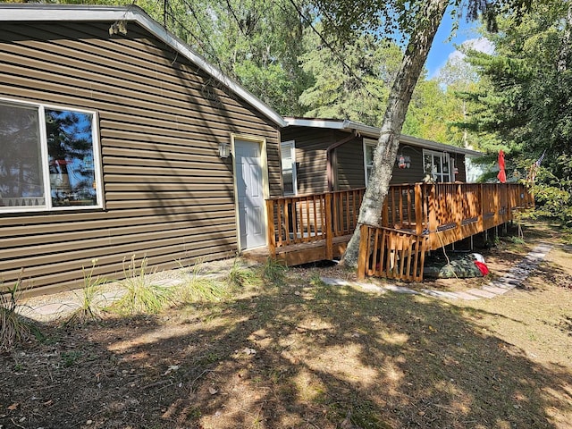 back of property featuring a deck