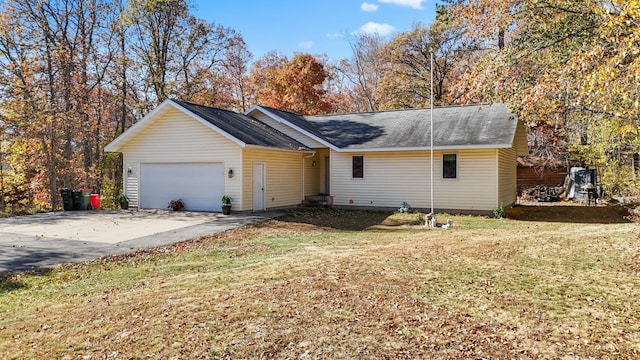 ranch-style home featuring a front yard, driveway, and an attached garage