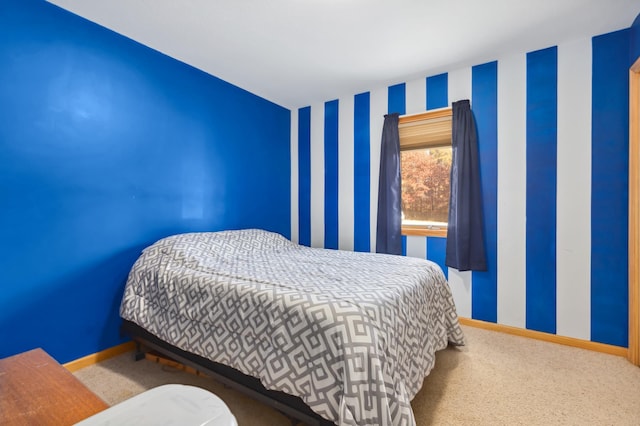 carpeted bedroom featuring baseboards