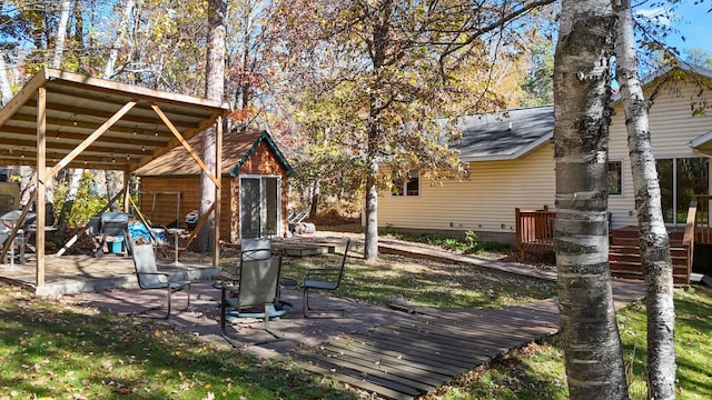 view of yard featuring a patio area, a storage unit, and an outdoor structure