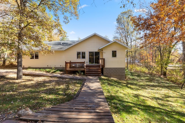 back of property with a deck and a lawn