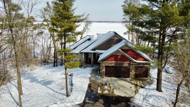 view of front of house with a garage and stone siding