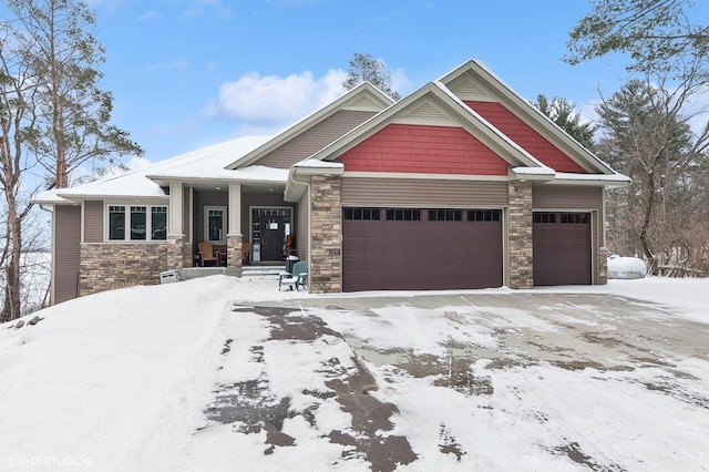 craftsman-style home with a garage and stone siding