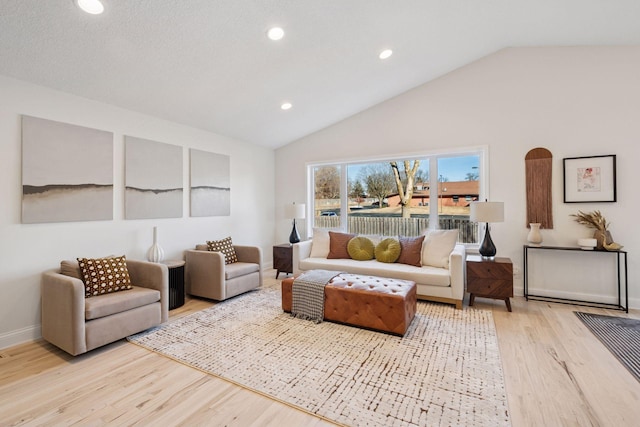 living area featuring lofted ceiling, light wood-style flooring, baseboards, and recessed lighting