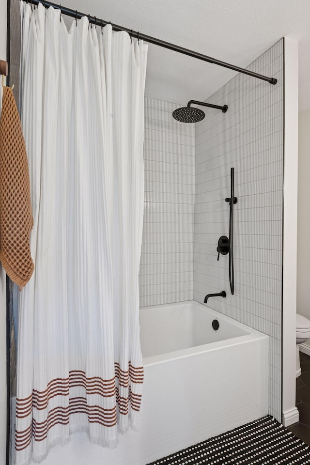 bathroom featuring toilet, tile patterned flooring, and shower / tub combo with curtain