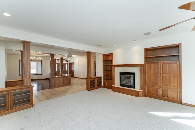 unfurnished living room with recessed lighting, a fireplace, decorative columns, baseboards, and light colored carpet