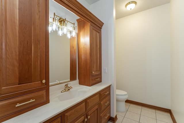 bathroom featuring tile patterned flooring, toilet, vanity, and baseboards