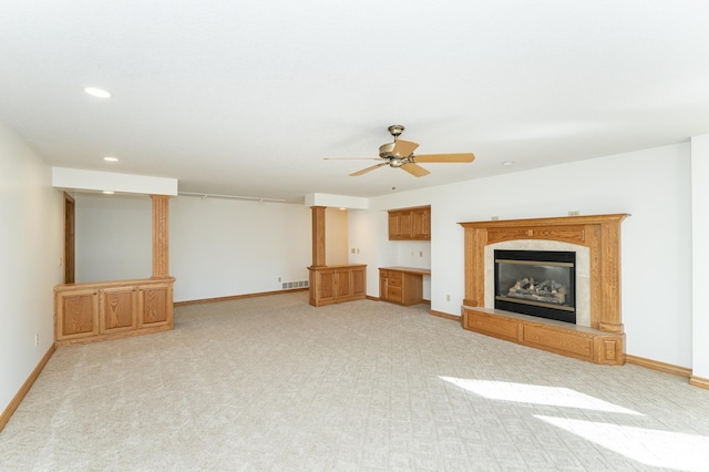 unfurnished living room with recessed lighting, a premium fireplace, baseboards, and visible vents