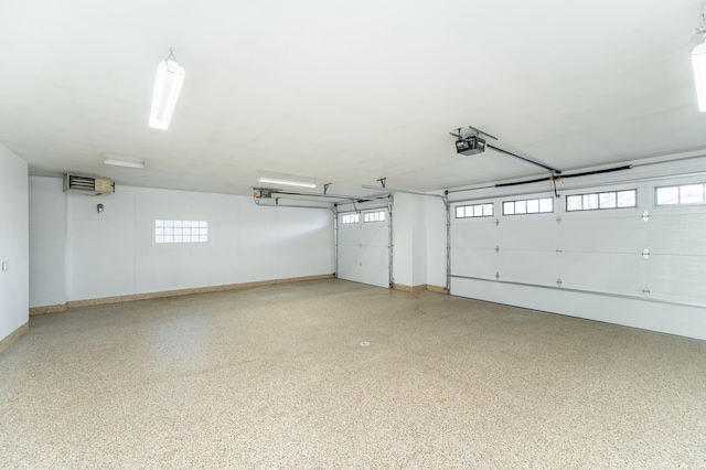 garage with a garage door opener and baseboards