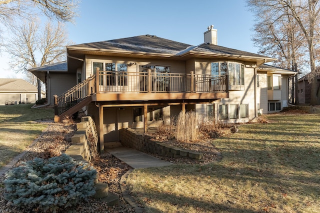 back of property with a yard, a deck, a chimney, and stairway