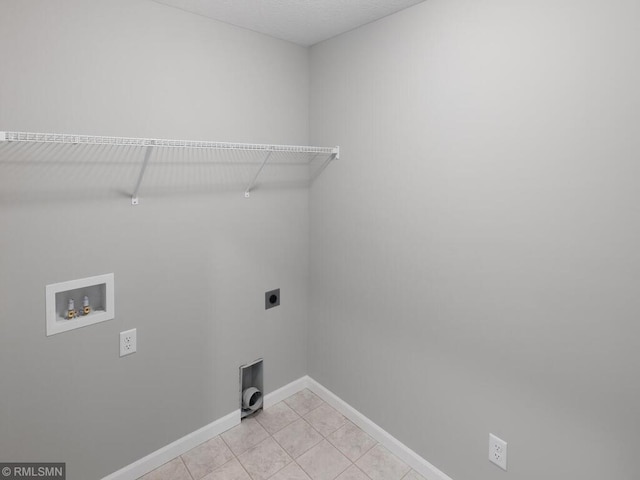 laundry area with hookup for a washing machine, light tile patterned floors, baseboards, hookup for an electric dryer, and laundry area