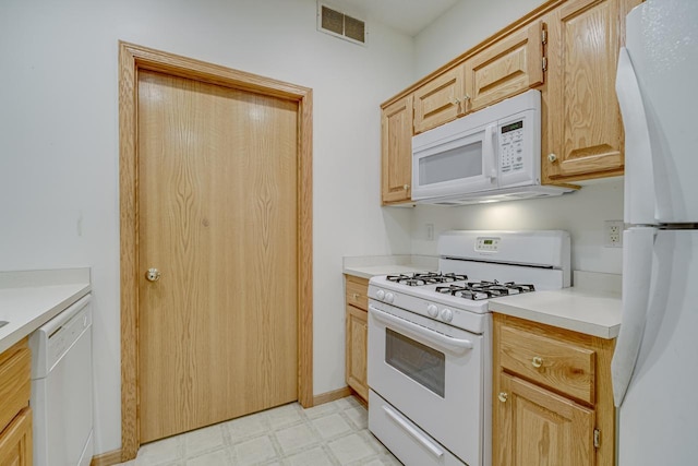 kitchen featuring light countertops, white appliances, visible vents, and light floors