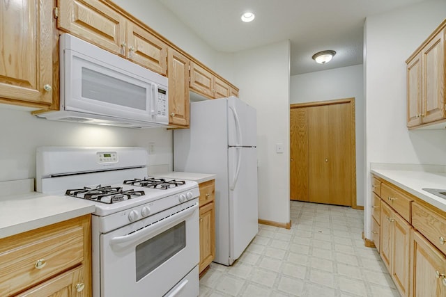 kitchen with light floors, recessed lighting, light countertops, white appliances, and baseboards