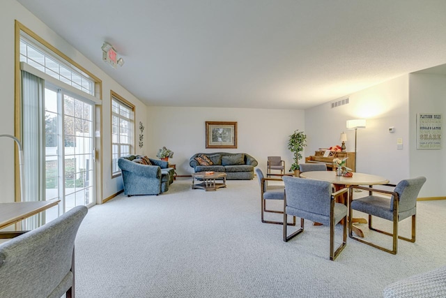 carpeted dining area with visible vents and baseboards