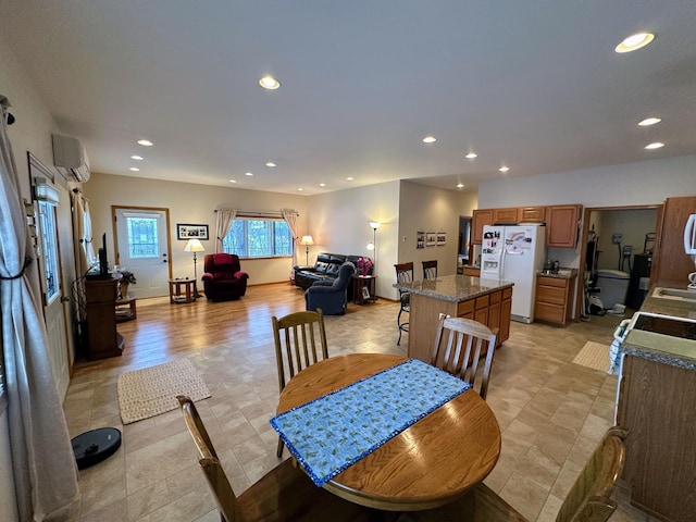 dining area featuring a wall mounted air conditioner and recessed lighting