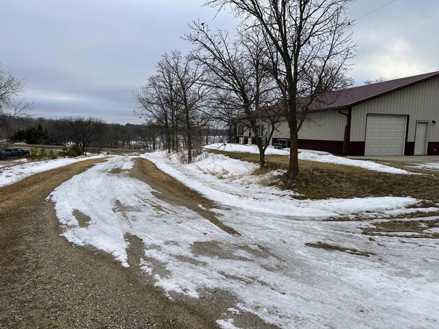 yard covered in snow with a detached garage