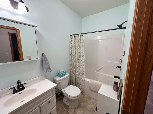 bathroom featuring toilet, tile patterned flooring, shower / bath combo with shower curtain, and vanity