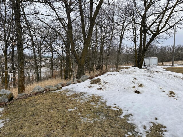 snowy yard with an outbuilding