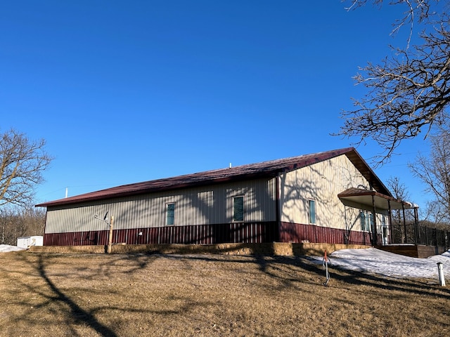 view of side of property with a lawn