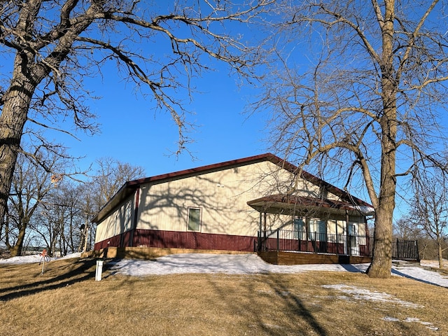 view of side of home featuring a lawn