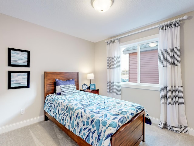 carpeted bedroom featuring baseboards