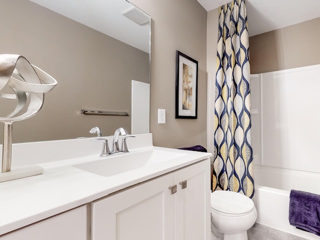 bathroom featuring toilet, visible vents, shower / bath combo with shower curtain, and vanity