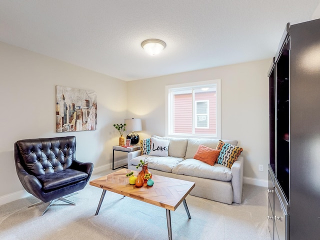 living area with baseboards and light colored carpet