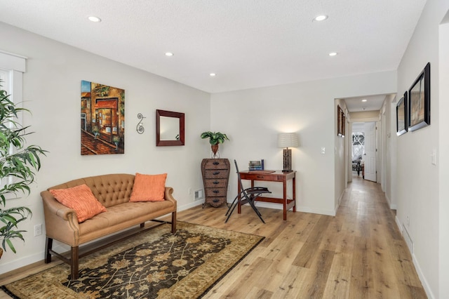 interior space with light wood-style flooring, baseboards, and recessed lighting