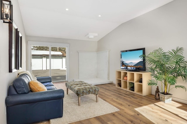 living area featuring recessed lighting, vaulted ceiling, and wood finished floors