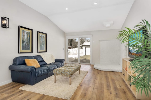 living room featuring lofted ceiling, recessed lighting, baseboards, and wood finished floors