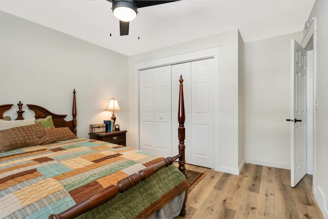 bedroom with light wood-style floors, a closet, ceiling fan, and baseboards