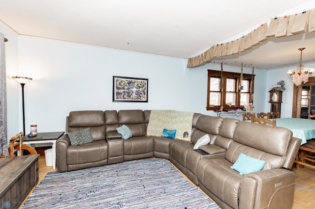 living area with a notable chandelier and light wood-style flooring