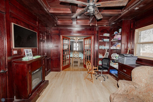 office space with crown molding, coffered ceiling, and wood walls