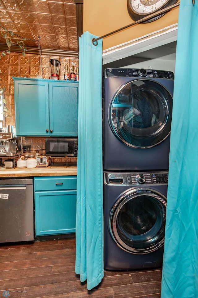 washroom with laundry area, an ornate ceiling, dark wood finished floors, and stacked washer / drying machine