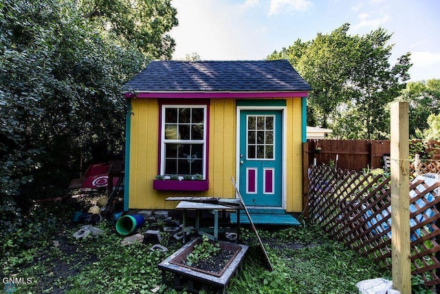 view of shed featuring fence