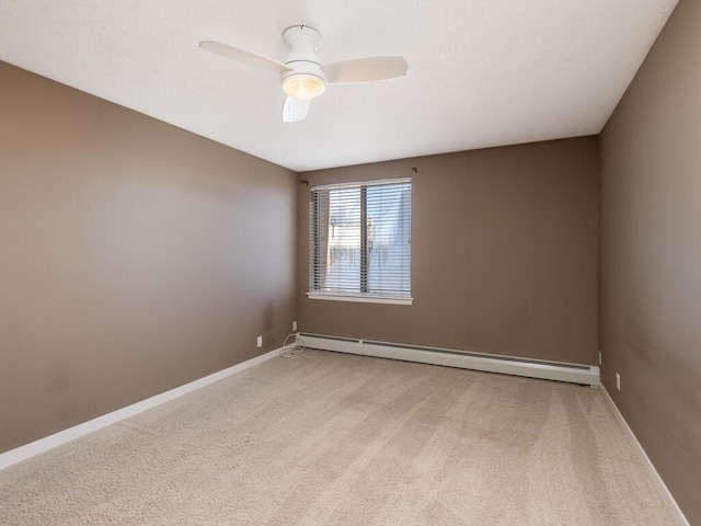 unfurnished room with baseboards, baseboard heating, a ceiling fan, and light colored carpet